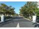 Granada Park gated entrance lined with mature trees showcases a secure and welcoming community at 1775 Stapleton St, Sarasota, FL 34239