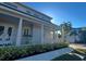 Side view of home with front porch, white pillars and railings, and neatly trimmed hedges at 1775 Stapleton St, Sarasota, FL 34239