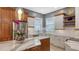 Well-appointed kitchen featuring custom cabinets, marble countertops, and modern appliances at 1775 Stapleton St, Sarasota, FL 34239