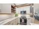 Stylish kitchen with white cabinets, stainless steel appliances and a tiled backsplash at 1775 Stapleton St, Sarasota, FL 34239