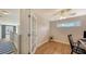 Home office with glass-top desk, wood floors, and ceiling fan at 1775 Stapleton St, Sarasota, FL 34239