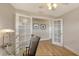 Bright office space with french doors, glass top desk, and wood look flooring at 1775 Stapleton St, Sarasota, FL 34239