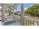 Relaxing covered porch offers a tranquil view of the street and lush greenery at 1775 Stapleton St, Sarasota, FL 34239