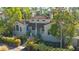 House with a tile roof surrounded by lush tropical landscaping at 1858 Oak St, Sarasota, FL 34236