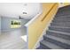 Gray carpeted staircase with yellow wall and view into living area at 206 Beacon Harbour Loop, Bradenton, FL 34212