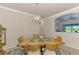 Bright dining room with a modern light fixture and glass-top table at 20720 Saluti Pl, Venice, FL 34293