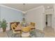 Dining area with light walls, a light wood table, and blue accent wall at 20720 Saluti Pl, Venice, FL 34293