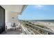Balcony view of a condo with chairs and white railings overlooking the white sands and ocean at 2105 Gulf Of Mexico Dr # 3303, Longboat Key, FL 34228