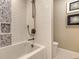 Luxurious bathtub with wave tile surround and modern fixtures at 2105 Gulf Of Mexico Dr # 3303, Longboat Key, FL 34228