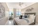 Inviting bedroom featuring cool colors, a ceiling fan, and tranquil ocean views at 2105 Gulf Of Mexico Dr # 3303, Longboat Key, FL 34228
