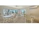 Bright common area with views of palms from the large windows and tables with seating at 2105 Gulf Of Mexico Dr # 3303, Longboat Key, FL 34228