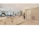 Gourmet kitchen featuring white cabinetry, a center island with bar seating, and an open-concept design at 2105 Gulf Of Mexico Dr # 3303, Longboat Key, FL 34228