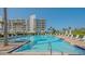 Resort-style swimming pool with lounge chairs and umbrellas, surrounded by lush landscaping at 2105 Gulf Of Mexico Dr # 3303, Longboat Key, FL 34228