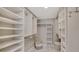 Spacious walk-in closet with custom shelving and well-lit storage, offering ample space for organization at 2105 Gulf Of Mexico Dr # 3303, Longboat Key, FL 34228