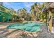 Freeform pool and spa surrounded by lush tropical landscaping at 264 Gladiolus St, Anna Maria, FL 34216