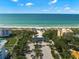 Aerial view of beach front property with resort-style amenities and parking at 3070 Grand Bay Blvd # 612, Longboat Key, FL 34228