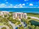 Waterfront condo building with lush landscaping and parking at 3070 Grand Bay Blvd # 612, Longboat Key, FL 34228