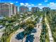 Aerial view of community entrance, lush landscaping, and building at 3070 Grand Bay Blvd # 612, Longboat Key, FL 34228