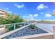Relaxing balcony with water views and stone landscaping at 3070 Grand Bay Blvd # 612, Longboat Key, FL 34228