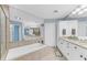 Elegant bathroom with double vanity, soaking tub, and separate shower at 3070 Grand Bay Blvd # 612, Longboat Key, FL 34228