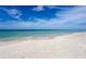 Serene beach with pristine white sand and calm ocean waters at 3070 Grand Bay Blvd # 612, Longboat Key, FL 34228