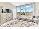 Bedroom with two twin beds, dresser, and access to balcony at 3070 Grand Bay Blvd # 612, Longboat Key, FL 34228