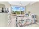 Two twin beds and a large window in this well-lit bedroom at 3070 Grand Bay Blvd # 612, Longboat Key, FL 34228