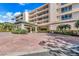 Elegant building entrance with covered walkway and landscaped grounds at 3070 Grand Bay Blvd # 612, Longboat Key, FL 34228