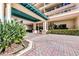 Elegant condo entrance with brick pavers and lush landscaping at 3070 Grand Bay Blvd # 612, Longboat Key, FL 34228