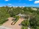 Aerial view of gated entrance to community with landscaping and parking at 3070 Grand Bay Blvd # 612, Longboat Key, FL 34228