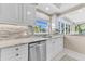 White kitchen cabinets, granite countertops, and a view at 3070 Grand Bay Blvd # 612, Longboat Key, FL 34228