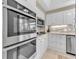 Stainless steel appliances and white cabinetry in this kitchen at 3070 Grand Bay Blvd # 612, Longboat Key, FL 34228