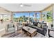 Bright living room with comfy seating, large windows, and water views at 3070 Grand Bay Blvd # 612, Longboat Key, FL 34228