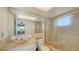 Bathroom with tub, shower, and updated vanity at 3806 Gulf Of Mexico Dr # C-312, Longboat Key, FL 34228