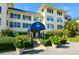 Condo building entrance with landscaping and awning at 3806 Gulf Of Mexico Dr # C-312, Longboat Key, FL 34228