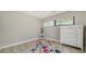 Simple bedroom with tile floors, natural light, and a colorful rug at 4409 Eleuthera Ct, Sarasota, FL 34233
