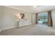 Bedroom with plush carpeting and neutral paint overlooking the backyard pool at 4409 Eleuthera Ct, Sarasota, FL 34233