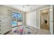 Bedroom with sliding glass door to pool and tile floors at 4409 Eleuthera Ct, Sarasota, FL 34233