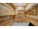 Wood-paneled walk-in closet with shelving, providing ample storage space at 4409 Eleuthera Ct, Sarasota, FL 34233