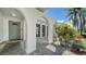 Covered entrance walkway featuring arched supports, decorative stone and garden plants at 4409 Eleuthera Ct, Sarasota, FL 34233