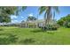 Beautiful single-story home with a well-manicured lawn and artistic plants along the facade at 4409 Eleuthera Ct, Sarasota, FL 34233