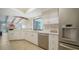 Bright kitchen with white cabinets, stainless steel appliances, and open layout to the living area at 4409 Eleuthera Ct, Sarasota, FL 34233