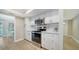 Well-lit kitchen with white cabinetry, modern appliances, and an open view to the dining area at 4409 Eleuthera Ct, Sarasota, FL 34233