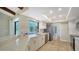 Modern kitchen with stainless steel refrigerator, white cabinets, and a view of the backyard pool at 4409 Eleuthera Ct, Sarasota, FL 34233
