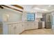 Spacious kitchen with white cabinets, stainless appliances, and a view to the pool at 4409 Eleuthera Ct, Sarasota, FL 34233