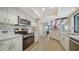 Updated kitchen featuring stainless steel appliances, white cabinetry, and a modern backsplash at 4409 Eleuthera Ct, Sarasota, FL 34233