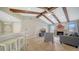 Inviting living room boasts vaulted ceilings with wood beams, fireplace, and tile flooring at 4409 Eleuthera Ct, Sarasota, FL 34233