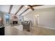 Living room with a fireplace, wooden beams, and large windows overlooking the yard at 4409 Eleuthera Ct, Sarasota, FL 34233