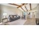 Cozy living room featuring exposed wood beams, comfortable seating, and tile flooring at 4409 Eleuthera Ct, Sarasota, FL 34233