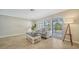 Inviting living room with comfortable seating, neutral walls, and two large windows for natural light at 4409 Eleuthera Ct, Sarasota, FL 34233